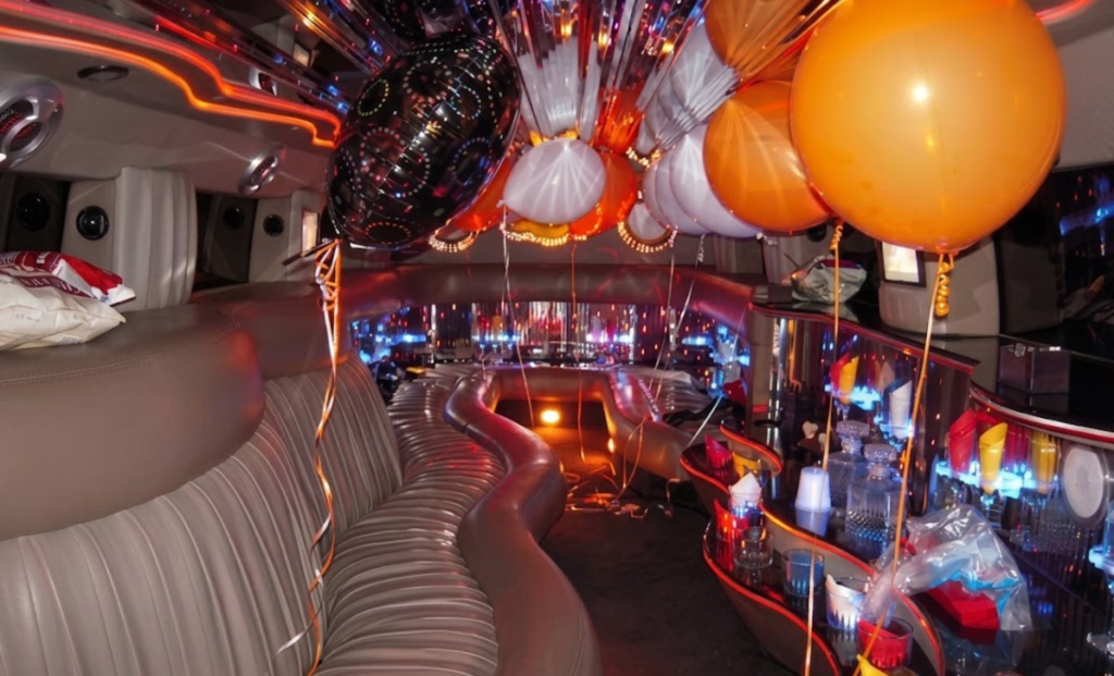 Decorated party bus interior with balloons for a group celebration